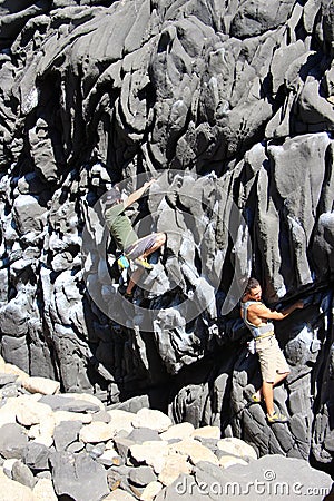 Rock climbers bouldering around the Concon coastline Editorial Stock Photo