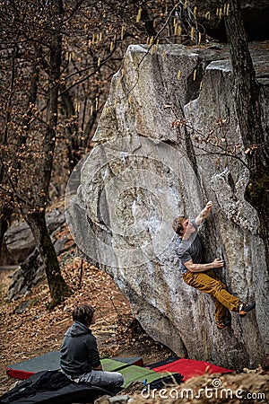 Rock climbers climbing on a boulder rock Stock Photo