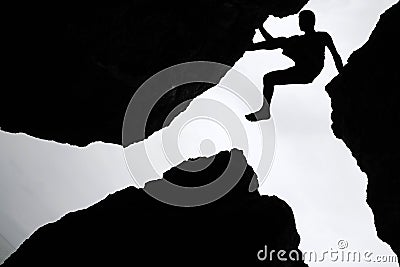 Rock climbing,Man climb between three rock on the cliff. Stock Photo