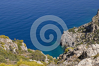 Rock coastline in Greece on island Telendos. Landscape view from hiking path. Stock Photo
