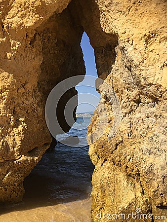 Rock crevice opening in Lagos, Portugal beach Stock Photo