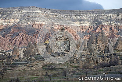 A rock with dwellings of ancient Christians on a gloomy January day. Cappadocia, Turkey Stock Photo