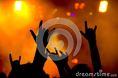 Rock fans showing horn sign Stock Photo