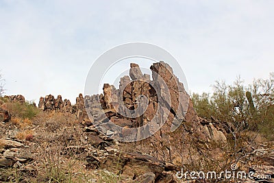 Jagged rocks and vegetation on the Piestewa Summit Trail in the mountains of Phoenix, Arizona Stock Photo