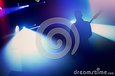 Rock guitarist silhouette on stage at concert. Stock Photo