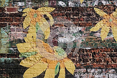 Rock Hill, South Carolina, USA - September 20, 2023: Cheerful yellow flowers painted on vintage brick wall Editorial Stock Photo