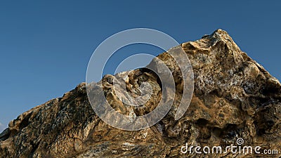 Rock /mountain in front of blue sky. Stock Photo