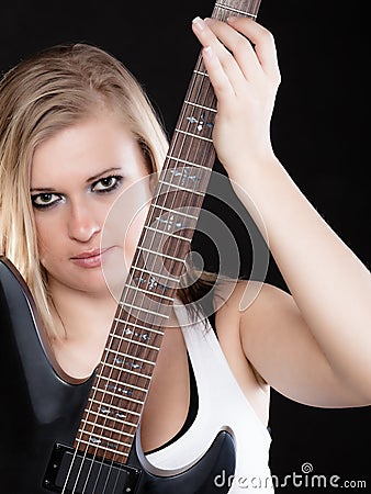 Rock music. Girl musician playing on electric guitar Stock Photo