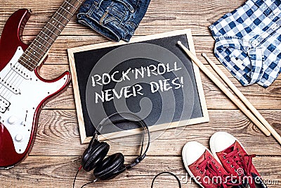 Rock`n`Roll background with blackboard, electric guitar, drumsti Stock Photo