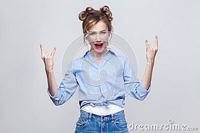 Rock n roll. Funny lady looking at camera with rock sing. Stock Photo