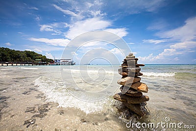 Rock Pyramid On The Beach Against Of The Sea Stock Photo