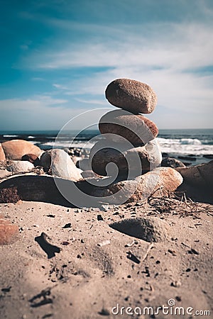 Rock pyramid on the beach by the seaside Stock Photo