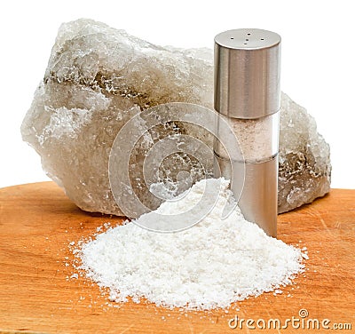 Rock salt with saltshaker and scattered salt Stock Photo