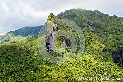 Rock with the shape of a Giant Tiki head on Raiatea island. Raiatea, Leeward Islands, Society Islands, French Polynesia, Oceania. Stock Photo