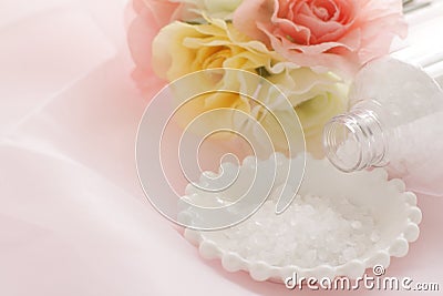 Rock slat on white plate with artificial flower Stock Photo