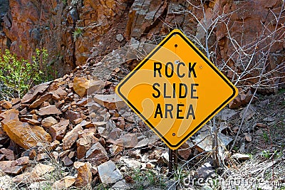 Rock Slide Area Sign with Fallen Rocks Stock Photo