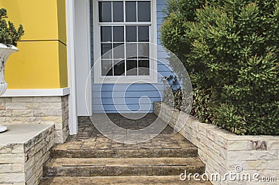 Rock stairs and floor with ornament plants beside the house Stock Photo