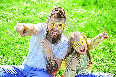 Rock star concept. Family spend leisure outdoors. Child and dad posing with star shaped eyeglases photo booth attribute Stock Photo