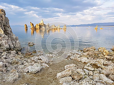 Rock tufa towers in the lake at sunset Stock Photo