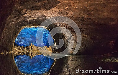 Rock wall reflected in the largest underground lake in Europe. Stock Photo