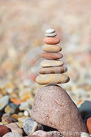 Rock zen pyramid of white, red and yellow stones. Concept of balance, harmony and meditation Stock Photo