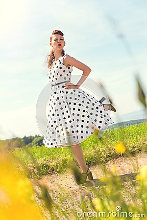 Rockabilly Girl on a path in the nature Stock Photo