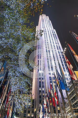 Rockefeller Center by night with international flags and lighting decorations - New York Editorial Stock Photo