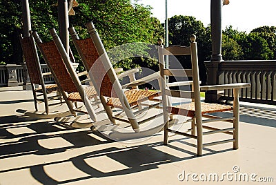 Rockers and straight chairs on a Victorian porch Stock Photo