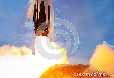 Rocket launch against blue sky Stock Photo