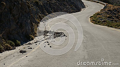 Rockfall - rocks fallen from a rocky cliff on the road Stock Photo