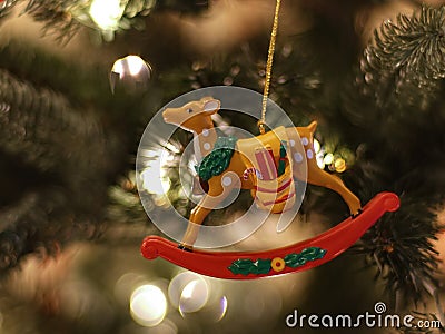 Rocking deer Christmas ornament hanging from tree. Stock Photo