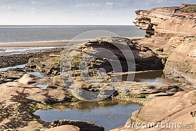 Rockpools and cliff at Hilbre Island, Wirral, England Stock Photo