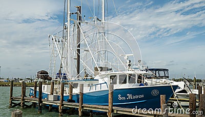 ROCKPORT, TX - 3 FEB 2020: Blue and white shrimp boat at a wooden dock Editorial Stock Photo