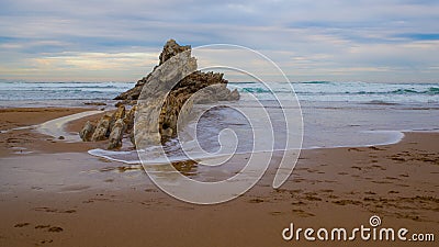 Rocks caressed by the sea on the beach Stock Photo