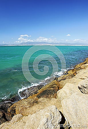 Rocks and clear green sea in Spain Stock Photo