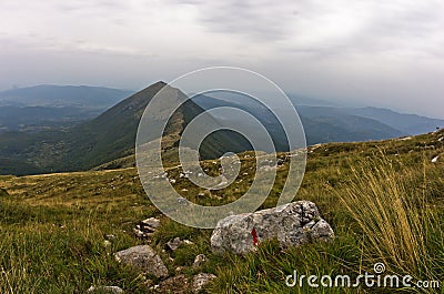 Rocks and cliffs under dark clouds trekking path at Suva Planina mountain Stock Photo