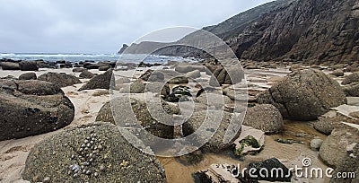 Rocks on cornall beach near lands end Stock Photo