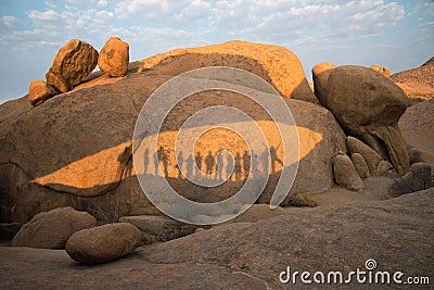 Rocks at Damaraland with the shadows of a group of people; sunny day Stock Photo