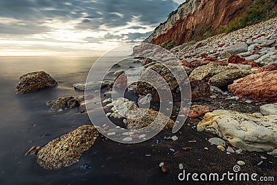 Rocks fallen from cliff over the north sea Stock Photo