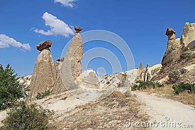 Rocks looking like mushrooms dramatically lit by a sun in Chavushin in Cappadocia, Turkey. Stock Photo