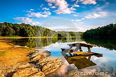 Rocks and a picnic table in Lake Marburg, at Codorus State Park, Pennsylvania. Stock Photo