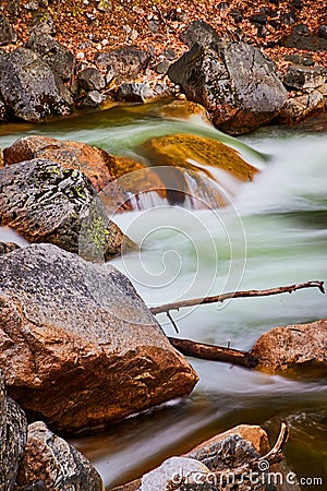 Rocks in river with cascading waters in early spring Stock Photo