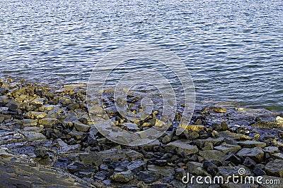 Rocks beside the riverbank Stock Photo