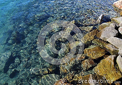 Rocks submerging in ocean Stock Photo