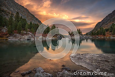 Rocks And Trees Reflecting In Pink Waters Of Sunset Mountain Lake, Altai Mountains Highland Nature Autumn Landscape Stock Photo