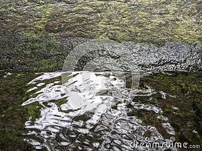 rocks, water and moss on the riverbank Stock Photo