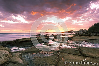 Rocks and waves at Kings Beach, QLD. Stock Photo