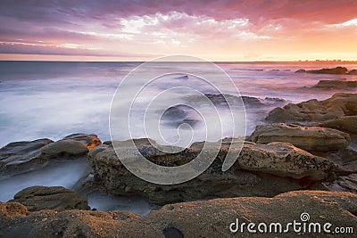 Rocks and waves at Kings Beach, QLD. Stock Photo