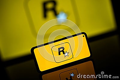 Rockstar games company logo on screen. Rockstar is international computer games developer Editorial Stock Photo