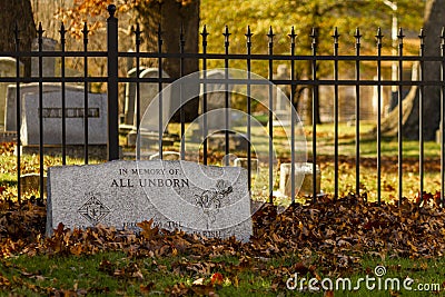 A tombstone in the grave yard by historic Saint Mary`s Church with fallen leaves covering it Editorial Stock Photo